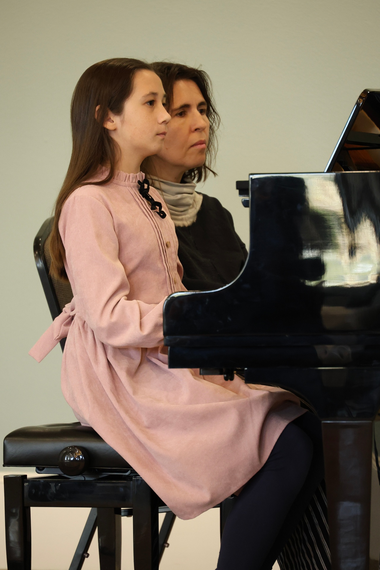 Rada Bukhman teaching a young piano student at a grand piano